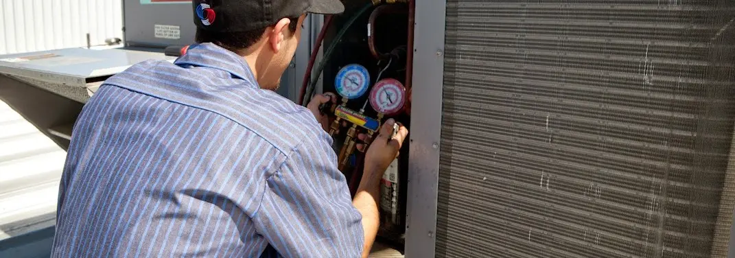 HVAC technician servicing a condenser unit in Sanford
